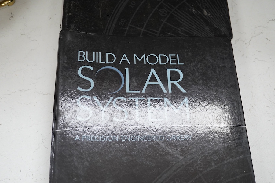 A precision brass orrery, a kit built electric operated astronomical orrery issued by Eaglemoss Publications as a part work ‘Build a Model Solar System’, complete with hardstone planets, brass moons, and a complete run o